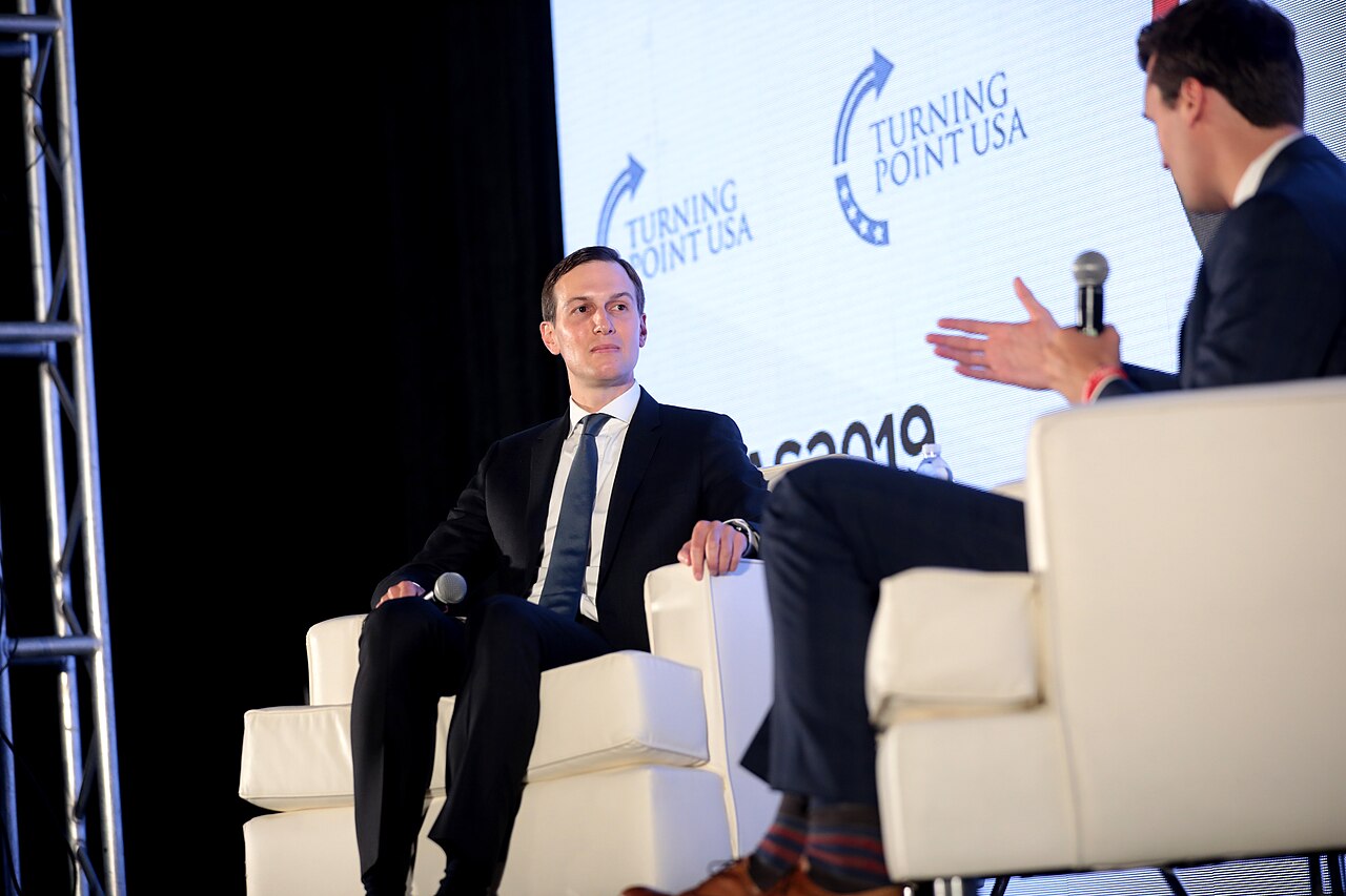 Jared Kushner seated on stage at a Turning Point USA event.